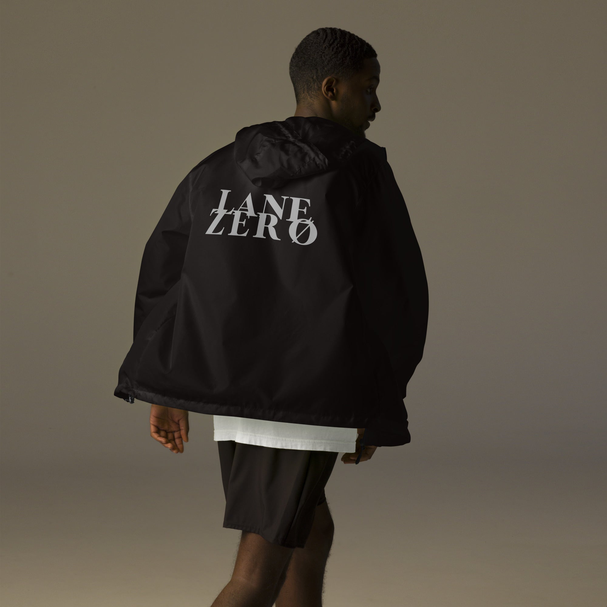 Person wearing a black jacket with 'LANE ZERO' branding on the back, standing against a plain background.